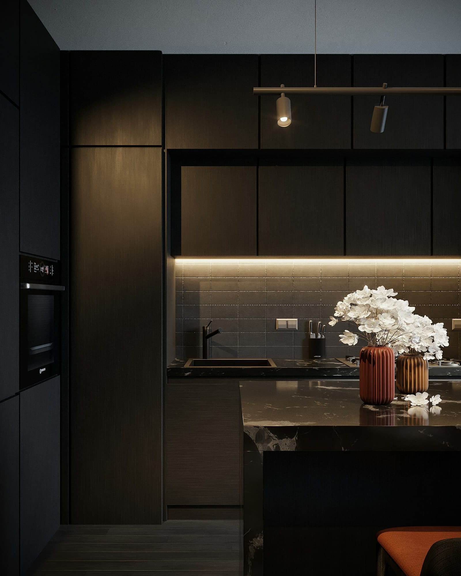 Cozinha planejada da DMJ com armários em tom escuro e iluminação em LED